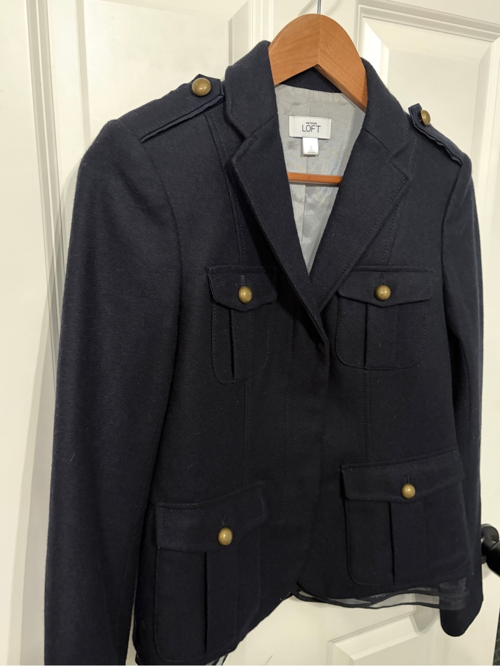 Beautiful Loft size 2 women’s wool
navy blue military blazer with ruffle hem.
